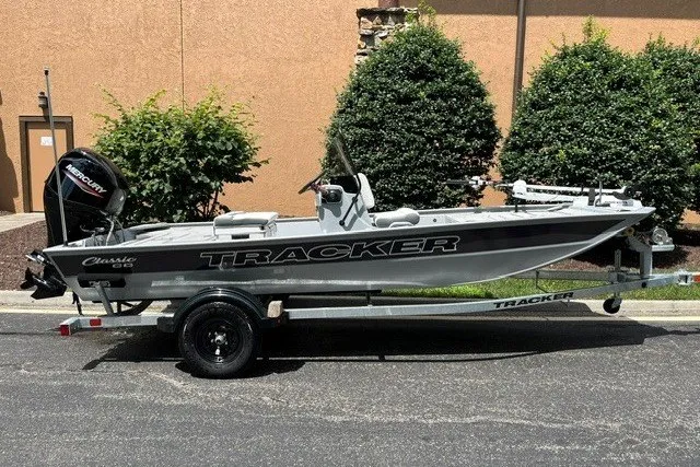 The Image of 2027 Tracker Bass Tracker Classic CC boat on trailer, parked outdoors. - 0