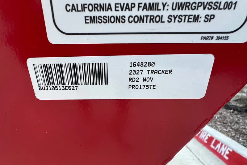 Slide: The Image of Sticker on red surface displaying 2027 Tracker Pro Team 175 model details and barcode. - 23