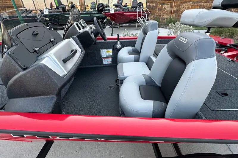Slide: The Image of 2027 Tracker Pro Team 175 boat interior with dual gray seats and steering console. - 14