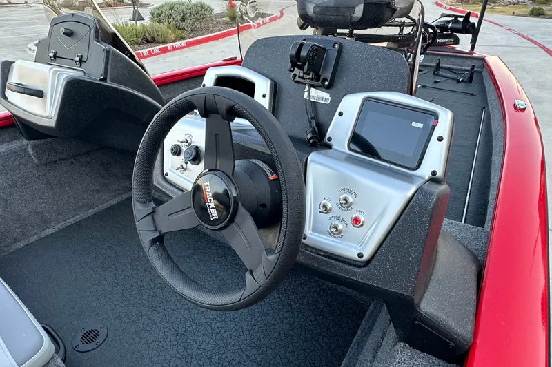 Slide: The Image of 2027 Tracker Pro Team 175 boat dashboard with steering wheel and control panel. - 21