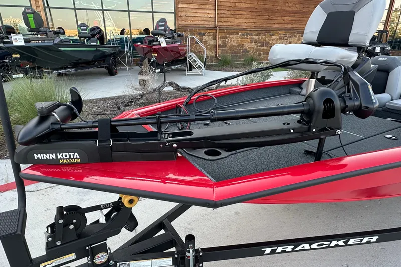 Slide: The Image of 2027 Tracker Pro Team 175 boat with Minn Kota Maxxum trolling motor, displayed outdoors. - 18