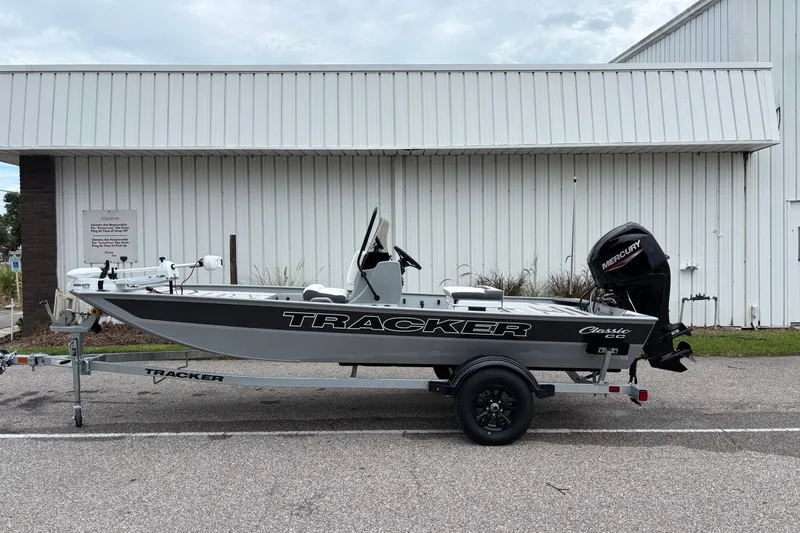 The Image of 2027 Tracker Bass Tracker Classic CC boat on trailer, parked outside a white building. - 0