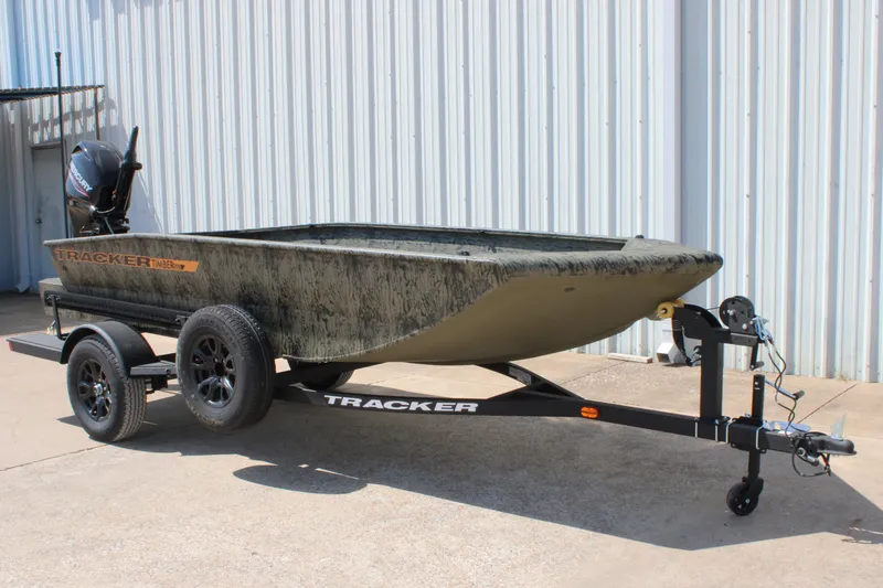 The Image of 2027 Tracker Grizzly 1553 Timber boat on trailer, parked outdoors. - 0