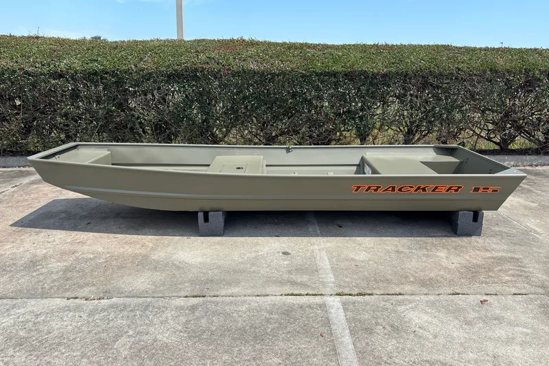 The Image of 2027 Tracker Grizzly 15 Jon boat on concrete, showcasing sleek design and durability. - 0