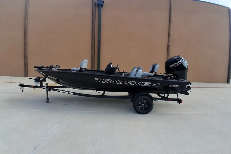 The Image of 2027 Tracker Pro Team 175 boat on trailer, side view, outdoors. - 0