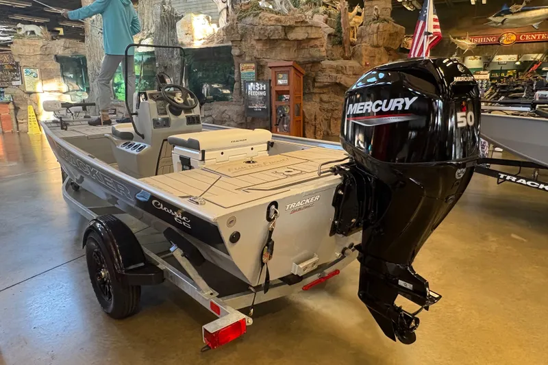 Slide: The Image of 2027 Tracker Bass Tracker Classic CC boat with Mercury 50 engine displayed indoors. - 50