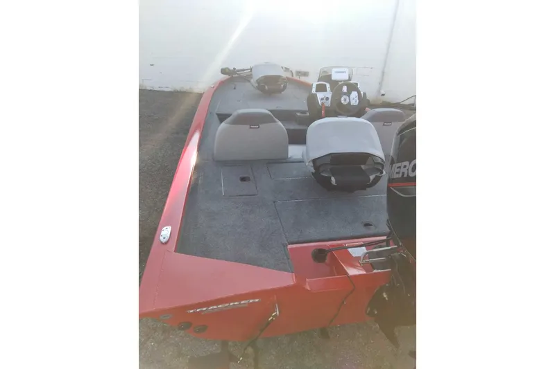Slide: The Image of 2027 Tracker Pro Team 175 boat, red exterior, dual seats, and Mercury engine. - 42