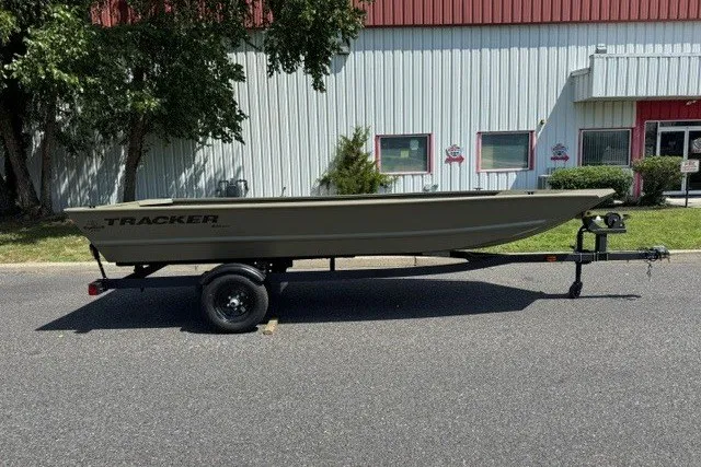 The Image of 2027 Tracker Grizzly 1648 Utility boat on trailer, parked outdoors. - 0