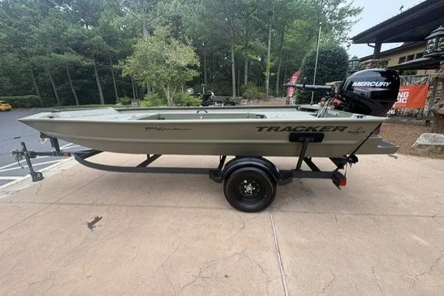 The Image of 2027 Tracker Grizzly 1654 T Sportsman boat on trailer, parked outdoors. - 0