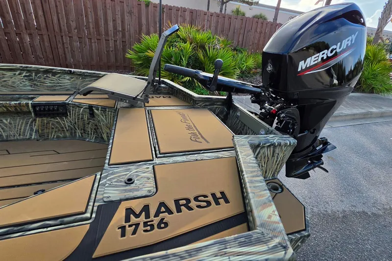 Slide: The Image of 2027 Tracker Grizzly 1756 T Marsh boat with Mercury outboard motor, camo design. - 16