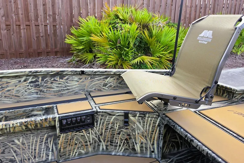 Slide: The Image of 2027 Tracker Grizzly 1756 T Marsh boat interior with camo design and adjustable seat. - 15