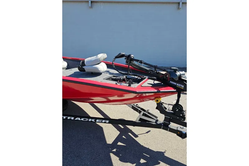 The Image of Red 2027 Tracker Pro Team 175 boat with Minn Kota trolling motor on trailer. - 0