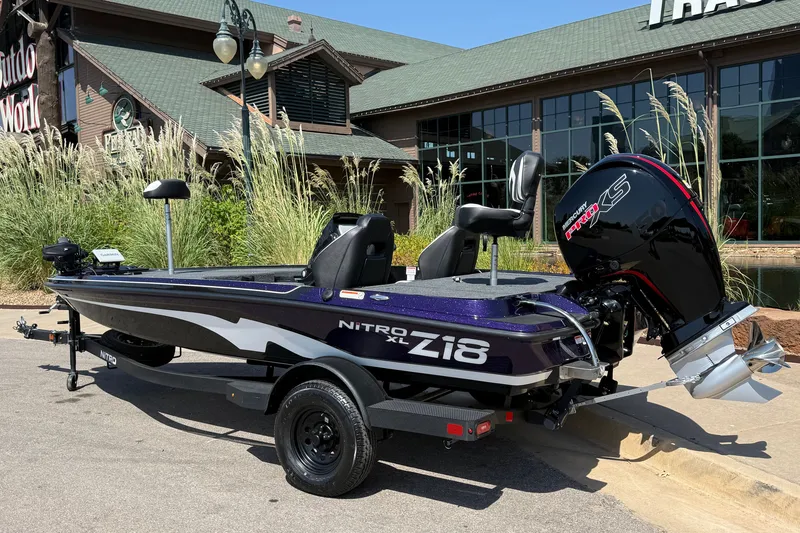 Slide: The Image of 2027 Nitro Z18 XL Pro boat parked outside a store, showcasing sleek design and powerful engine. - 1