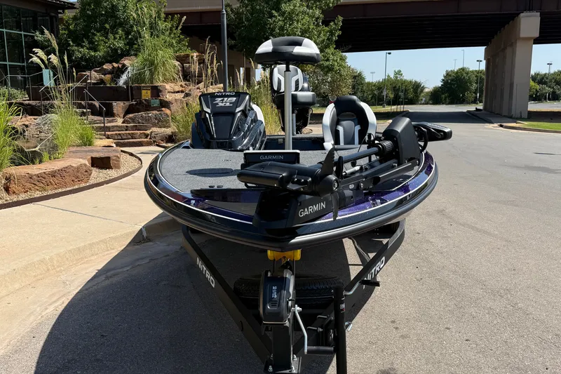 Slide: The Image of 2027 Nitro Z18 XL Pro boat with Garmin equipment, parked outdoors near a landscaped area. - 3