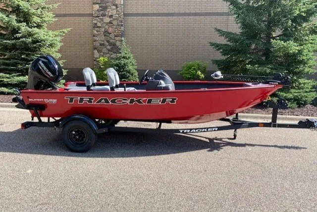 The Image of 2027 Tracker Super Guide V-16 SC boat in vibrant red on a trailer. - 0