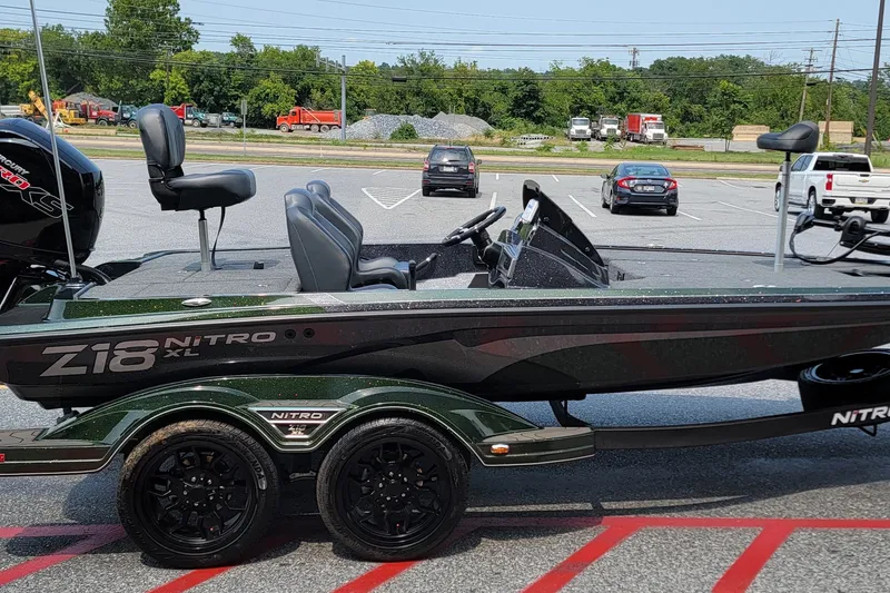 Slide: The Image of 2027 Nitro Z18 XL boat on trailer in parking lot, side view. - 2
