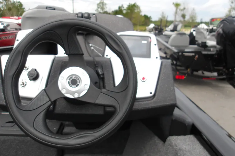 Slide: The Image of Steering wheel of 2027 Tracker Pro Team 175 boat, featuring modern dashboard controls. - 15