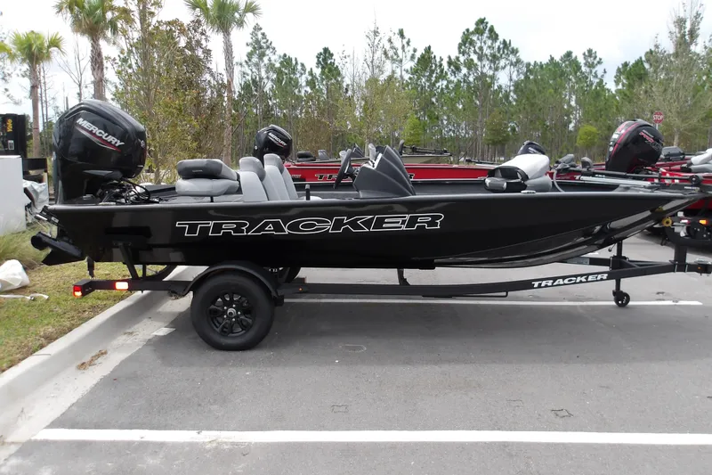 The Image of 2027 Tracker Pro Team 175 boat on trailer, parked outdoors. - 1