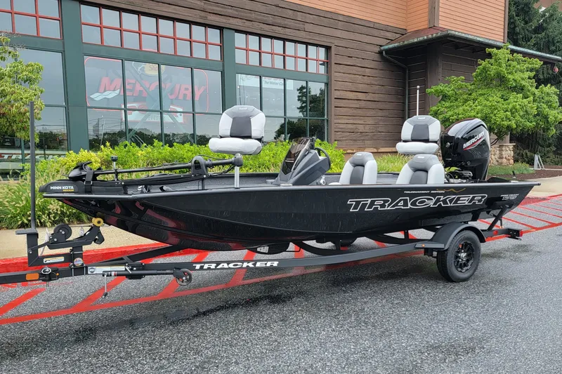 The Image of 2027 Tracker Pro Team 175 boat on trailer, parked outside a building. - 0