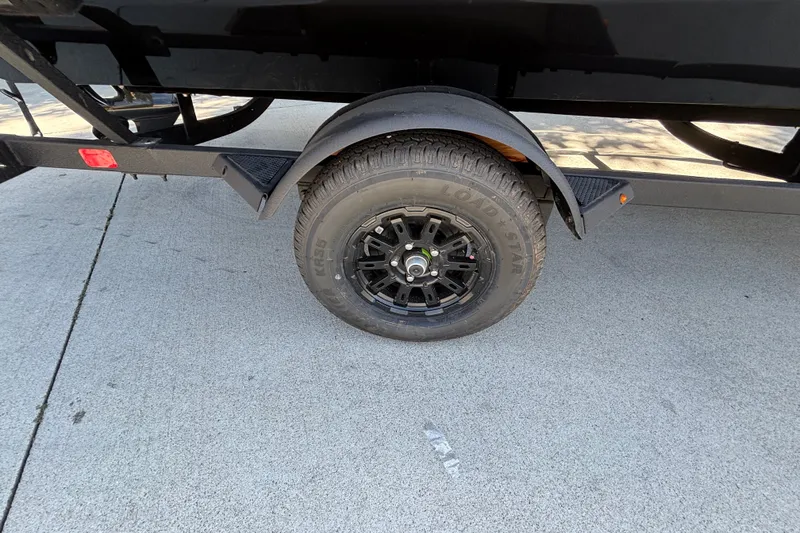 Slide: The Image of Trailer wheel of 2027 Tracker Pro Team 175 on concrete surface. - 29