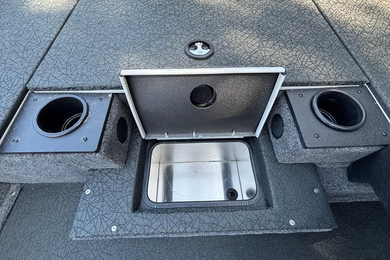 Slide: The Image of 2027 Tracker Pro Team 175 boat interior with open storage compartment and cup holders. - 28