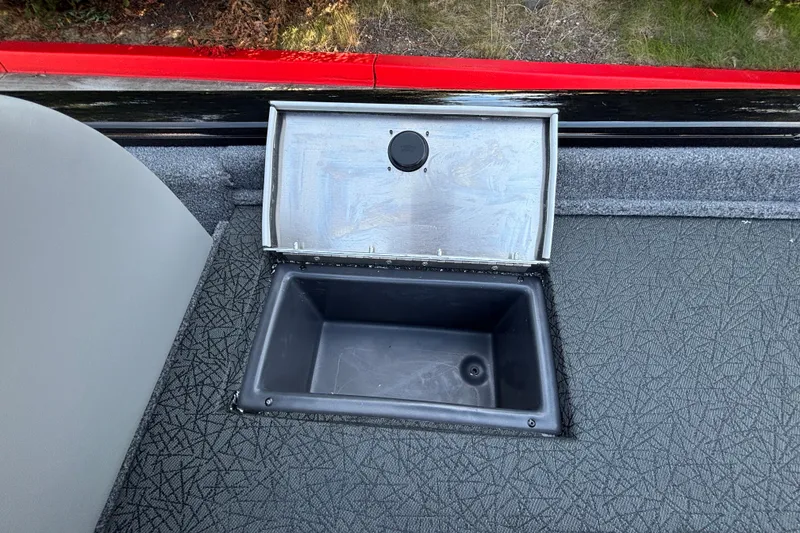 Slide: The Image of Open storage compartment on 2027 Tracker Pro Team 175 boat, featuring textured flooring. - 20
