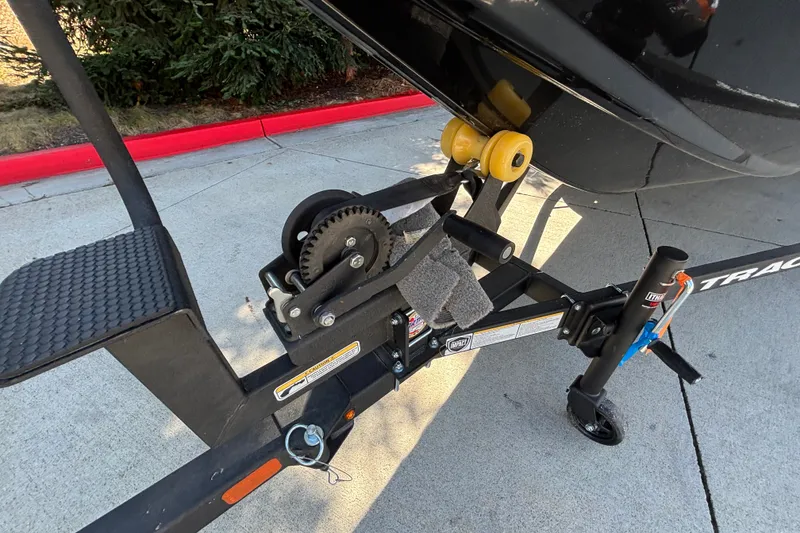 Slide: The Image of Trailer hitch of 2027 Tracker Pro Team 175 boat on pavement. - 31