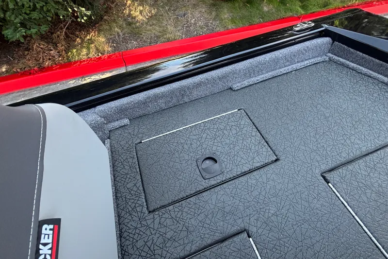 Slide: The Image of 2027 Tracker Pro Team 175 boat interior with textured flooring and storage compartment. - 23