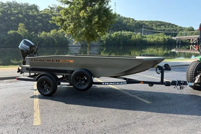 Slide: The Image of 2027 Tracker Grizzly 1553 Timber boat on trailer by a scenic lake. - 14
