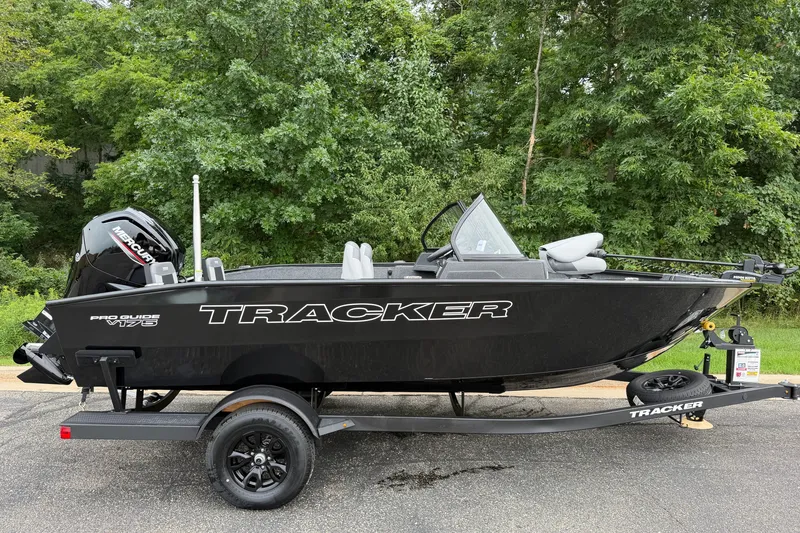 The Image of 2027 Tracker Pro Guide V-175 Combo boat on trailer, parked outdoors. - 0