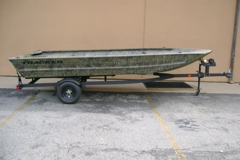The Image of 2027 Tracker Grizzly 1648 Utility boat on trailer, parked on concrete surface. - 0