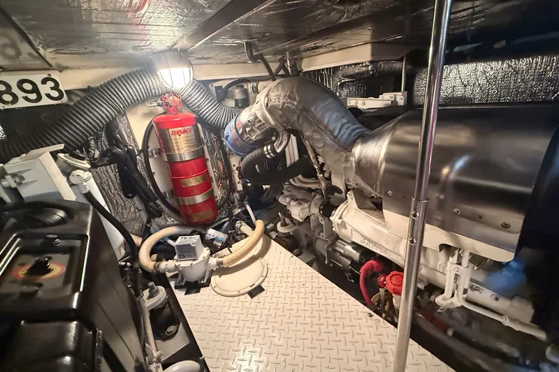 Slide: The Image of Engine room of 2007 Cruisers Yachts 455 Express Motoryacht with fire extinguisher and mechanical components. - 17