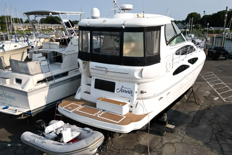 Slide: The Image of 2007 Cruisers Yachts 455 Express Motoryacht docked with inflatable boat nearby. - 3
