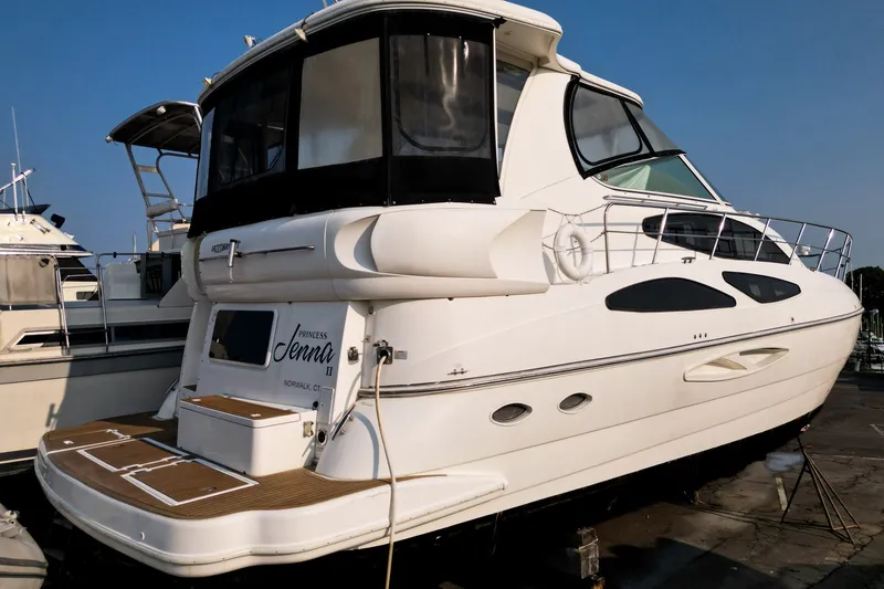 Slide: The Image of 2007 Cruisers Yachts 455 Express Motoryacht docked, featuring sleek design and spacious deck. - 2