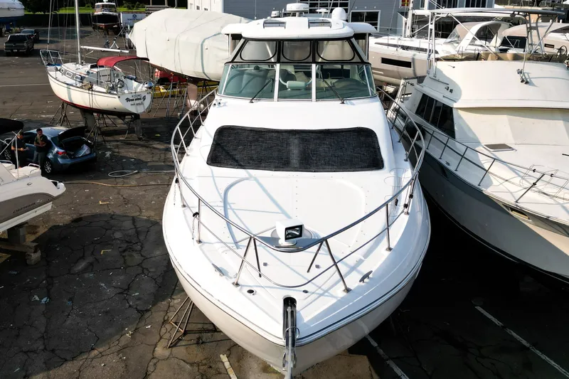 Slide: The Image of 2007 Cruisers Yachts 455 Express Motoryacht docked in a marina. - 1