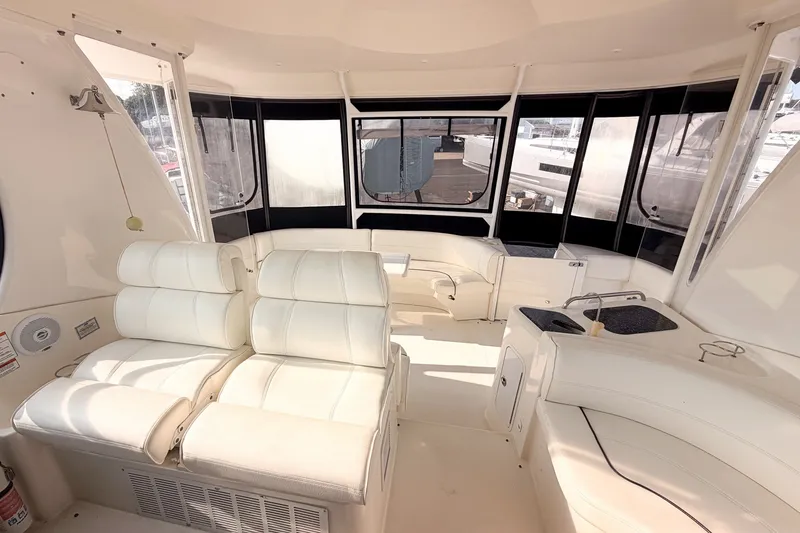 Slide: The Image of Luxurious interior of 2007 Cruisers Yachts 455 Express Motoryacht with white seating and windows. - 7