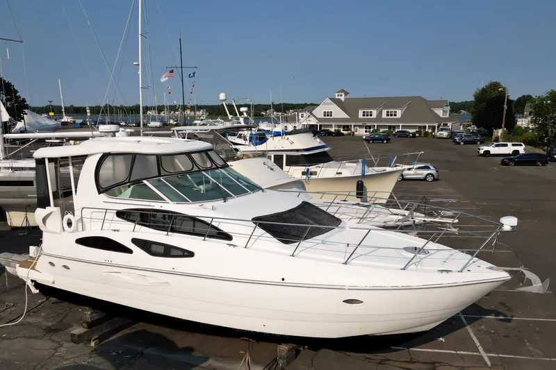 Slide: The Image of 2007 Cruisers Yachts 455 Express Motoryacht docked at a marina, surrounded by other boats. - 4