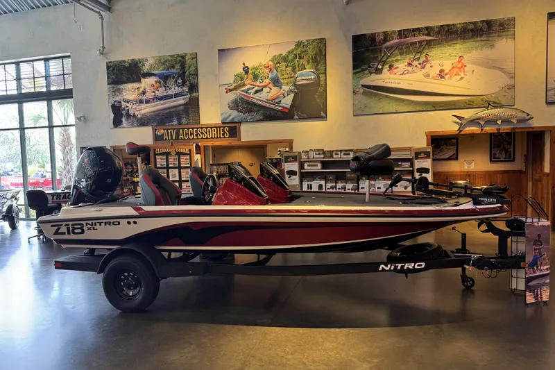 Slide: The Image of 2027 Nitro Z18 XL boat displayed in showroom with promotional posters and accessories. - 2