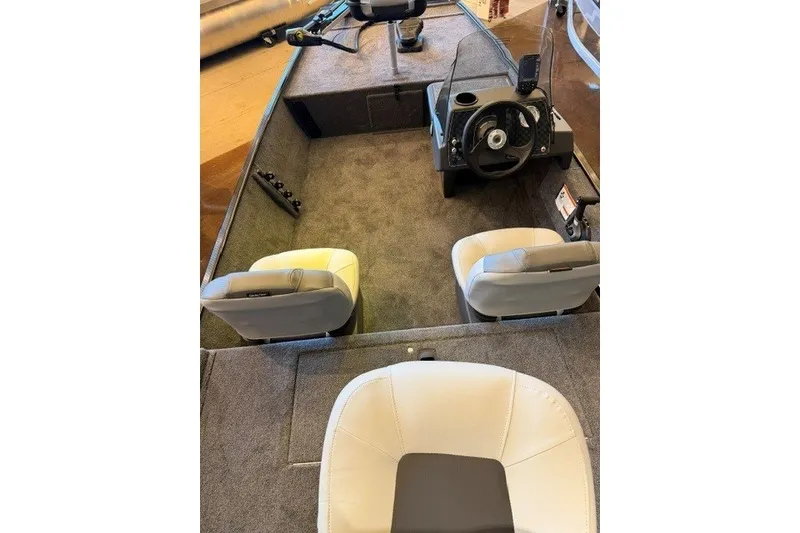 Slide: The Image of 2027 Tracker Bass Tracker Classic XL boat interior with steering wheel and seating. - 16