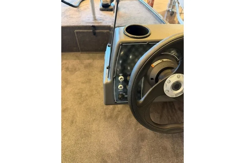 Slide: The Image of Steering console of 2027 Tracker Bass Tracker Classic XL boat with cup holder. - 13