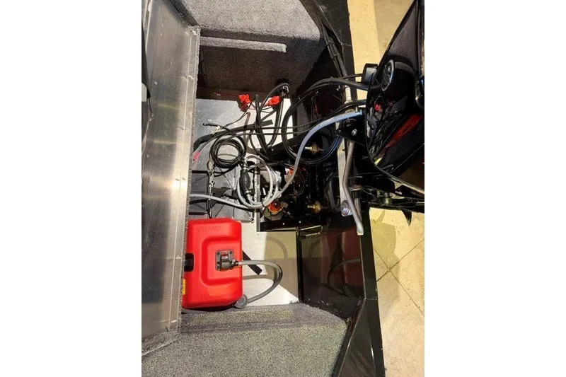 Slide: The Image of Interior view of 2027 Tracker Bass Tracker Classic XL boat showing wiring and fuel tank. - 17