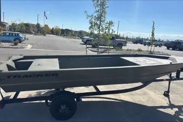 The Image of 2027 Tracker Grizzly 1648 Utility boat on trailer in parking lot. - 0