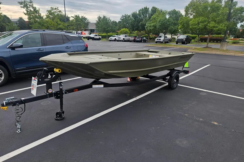 The Image of 2027 Tracker Grizzly 1648 Utility boat on trailer in parking lot. - 0