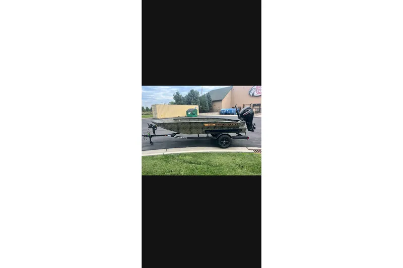 The Image of 2027 Tracker Grizzly 1553 Timber boat on trailer, parked outdoors. - 0