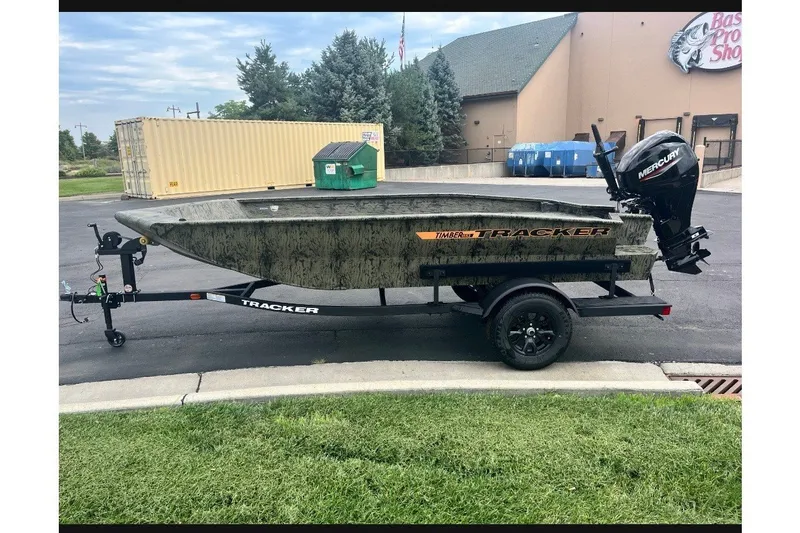 The Image of 2027 Tracker Grizzly 1553 Timber boat on trailer, parked outdoors. - 0