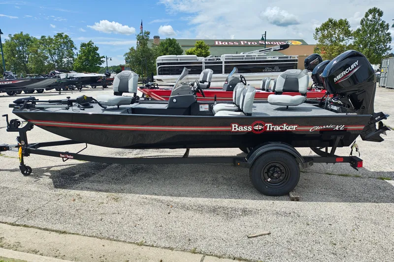 The Image of 2027 Tracker Bass Tracker Classic XL boat on trailer at Bass Pro Shops parking lot. - 0