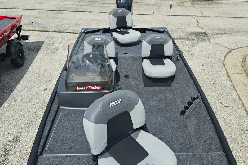 Slide: The Image of 2027 Tracker Bass Tracker Classic XL boat interior with gray seating and steering console. - 19