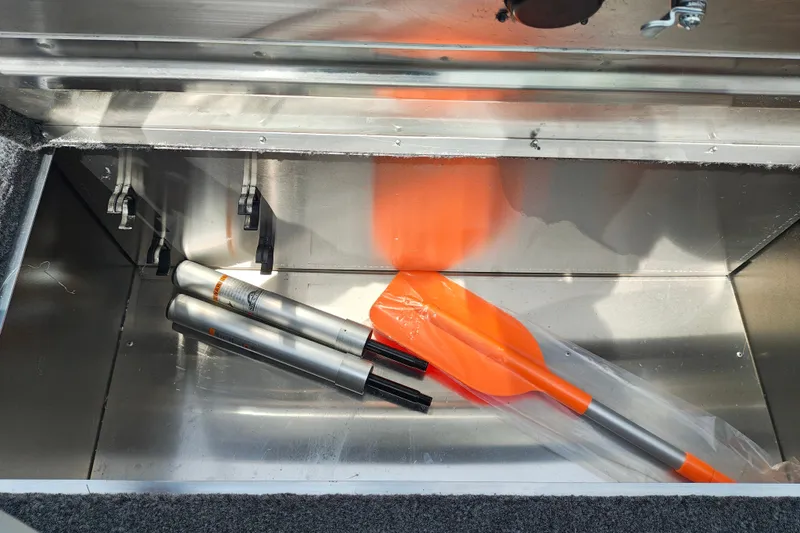 Slide: The Image of Storage compartment in 2027 Tracker Bass Tracker Classic XL with orange paddles. - 22