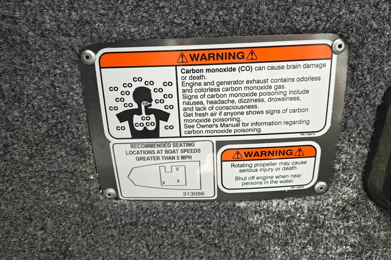 Slide: The Image of Warning labels on 2027 Tracker Bass Tracker Classic XL boat, cautioning against carbon monoxide and propeller hazards. - 13