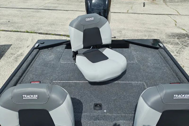 Slide: The Image of 2027 Tracker Bass Tracker Classic XL boat seats on carpeted deck. - 21